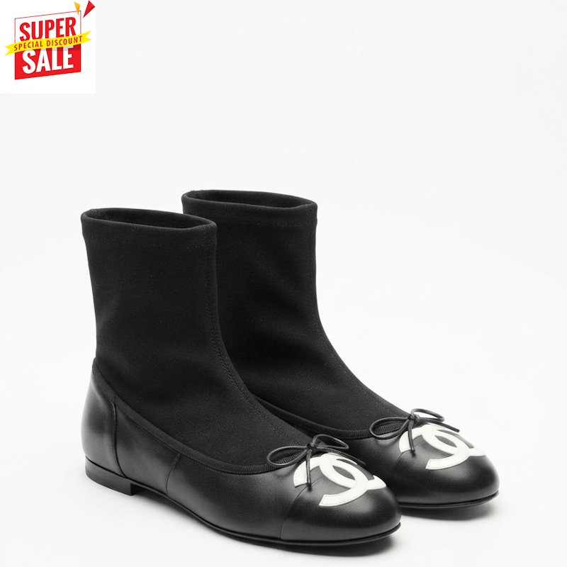 A pair of black Chanel ballet flats with elastic sock-like upper sections and a white interlocking CC logo on the toe, shown on a white background with a 'SUPER SALE' graphic overlay in the top-left corner.