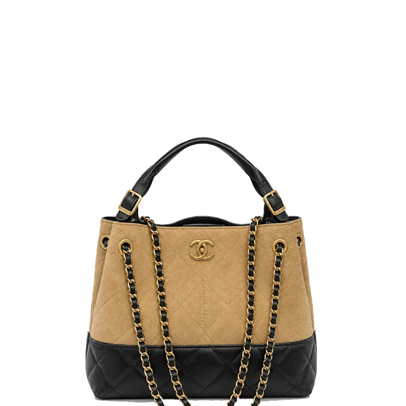 A  handbag in beige quilted suede and black leather, featuring a gold-tone interlocking CC logo, top handle, and chain strap on a plain white background.