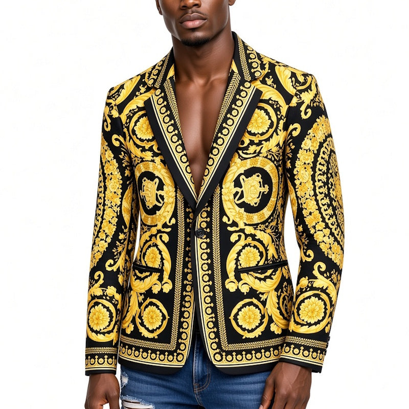 A man wearing a black and gold baroque-patterned blazer jacket, paired with blue jeans, against a plain white background.
