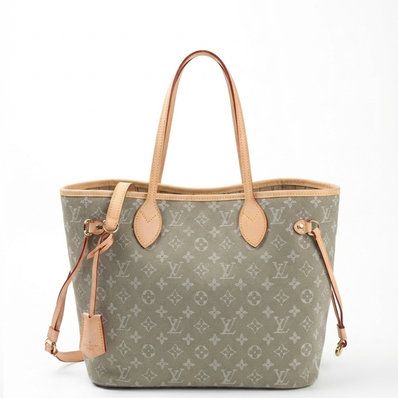  Neverfull tote bag in Monogram canvas with light tan leather handles and trim, shown on a plain white background.