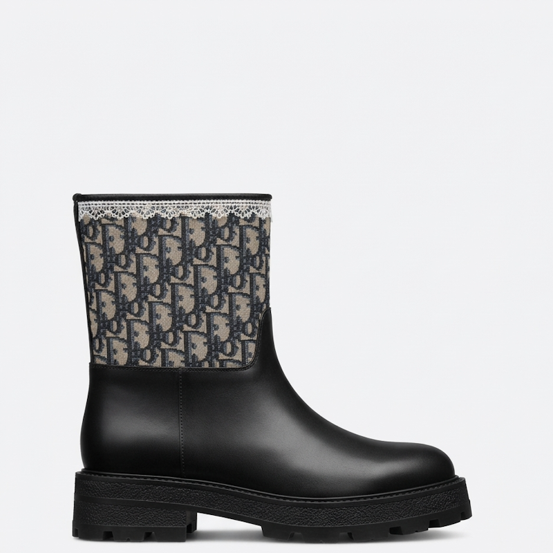 A black leather ankle boot with a thick lug sole, featuring a beige and black  Oblique monogram patterned fabric collar.